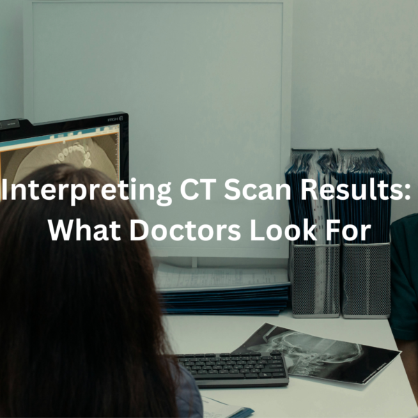 Medical professionals discussing CT scan results on a computer screen.