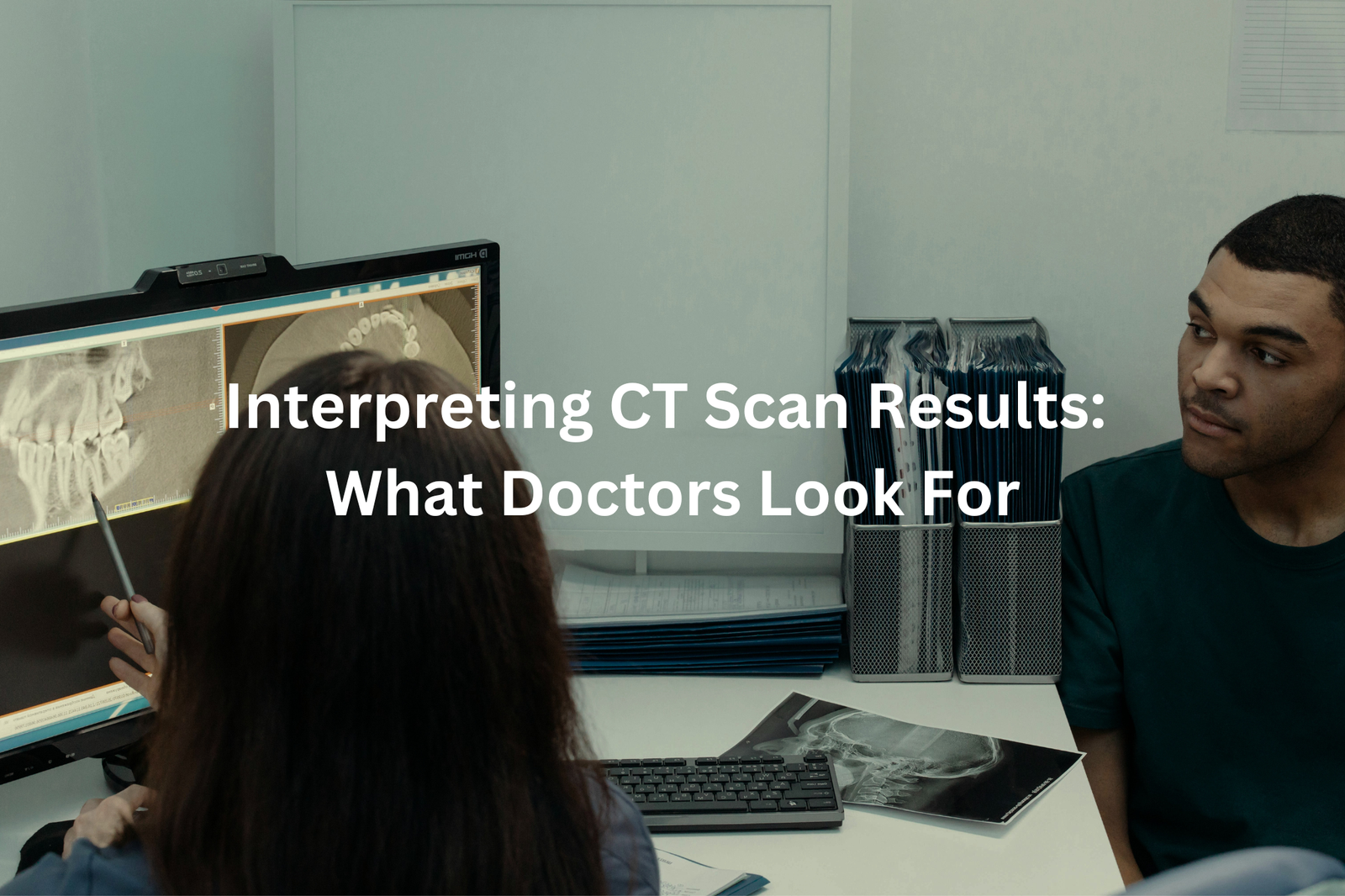 Medical professionals discussing CT scan results on a computer screen.