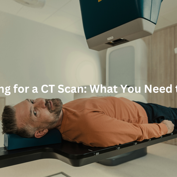 A patient being prepared for a CT scan, lying on a table in a medical facility.