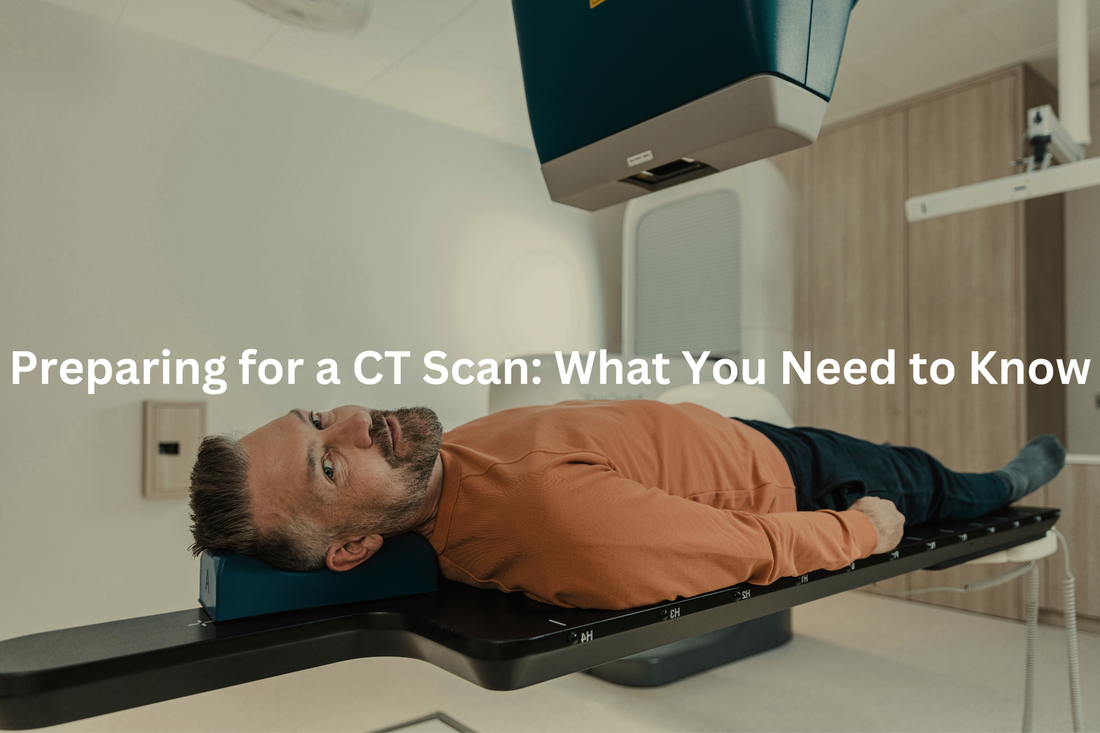 A patient being prepared for a CT scan, lying on a table in a medical facility.