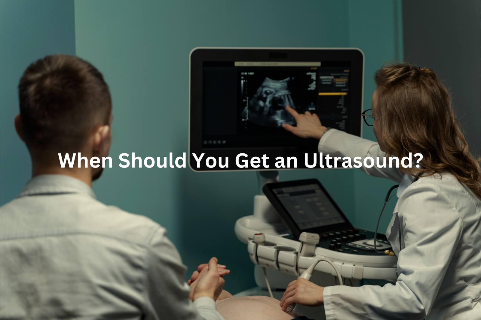 Medical professionals examining ultrasound image on computer