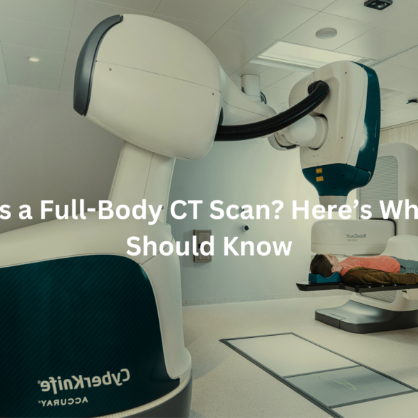 A full-body CT scan machine with a patient lying on the examination table, accompanied by the text "What Is a Full-Body CT Scan? Here's What You Should Know"