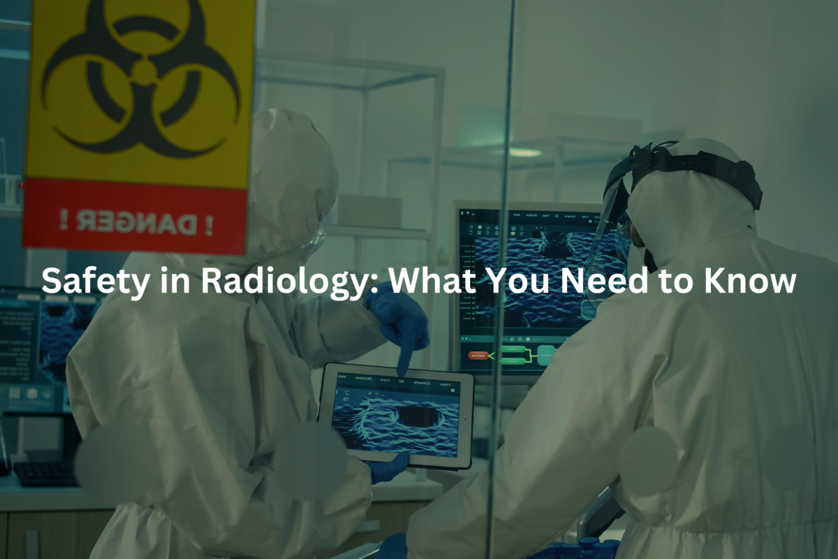 Two healthcare workers in protective gear examining a medical imaging scan displayed on a tablet in a radiology department.