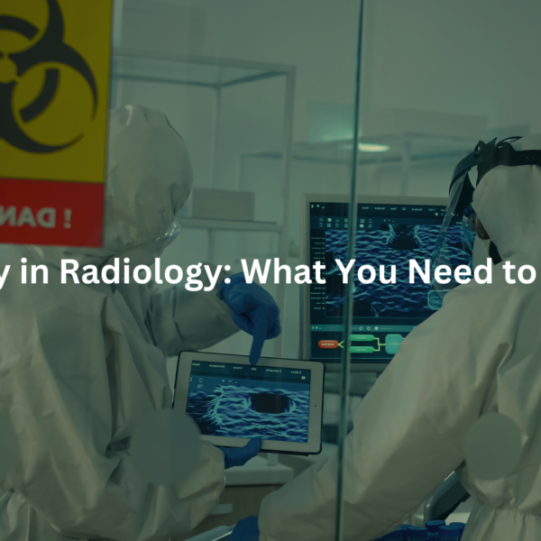 Two healthcare workers in protective gear examining a medical imaging scan displayed on a tablet in a radiology department.